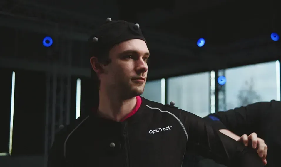 Close view of a person in a motion capture suit in a motion capture volume.