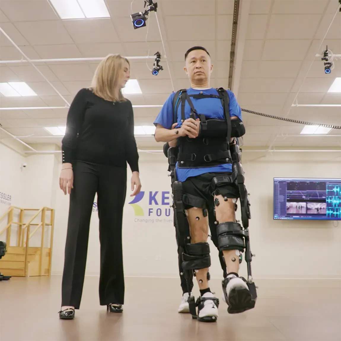 Person walking using exoskeleton on their legs.